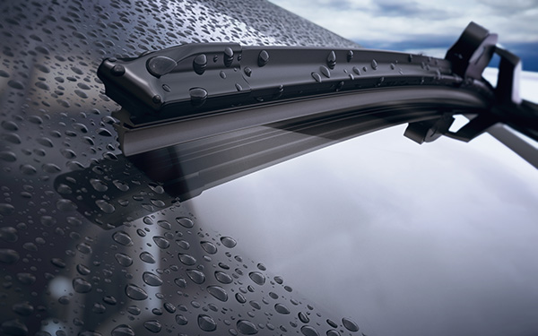 A Topex OEM wiper blade installed on a car windshield, clearing rain with a clear view, showcasing perfect fitment.