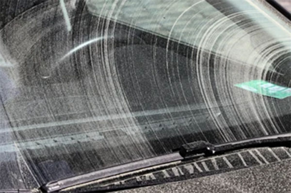 Close-up of a cracked wiper blade damaged by UV and heat exposure.