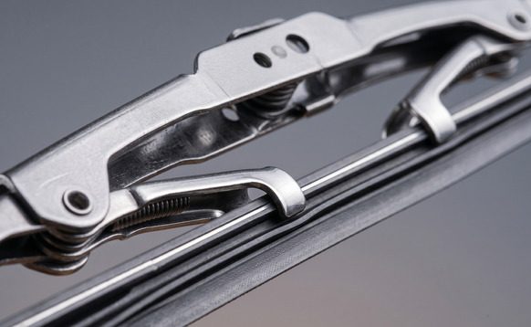 Close-up of a conventional framed wiper blade showing the metal superstructure and rubber element
