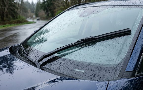 Toyota OEM wiper blades professionally installed on a RAV4 windshield