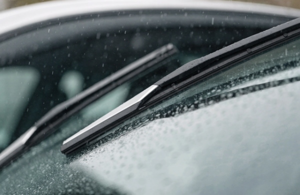 Quiet beam wiper blades gliding silently on wet windshield